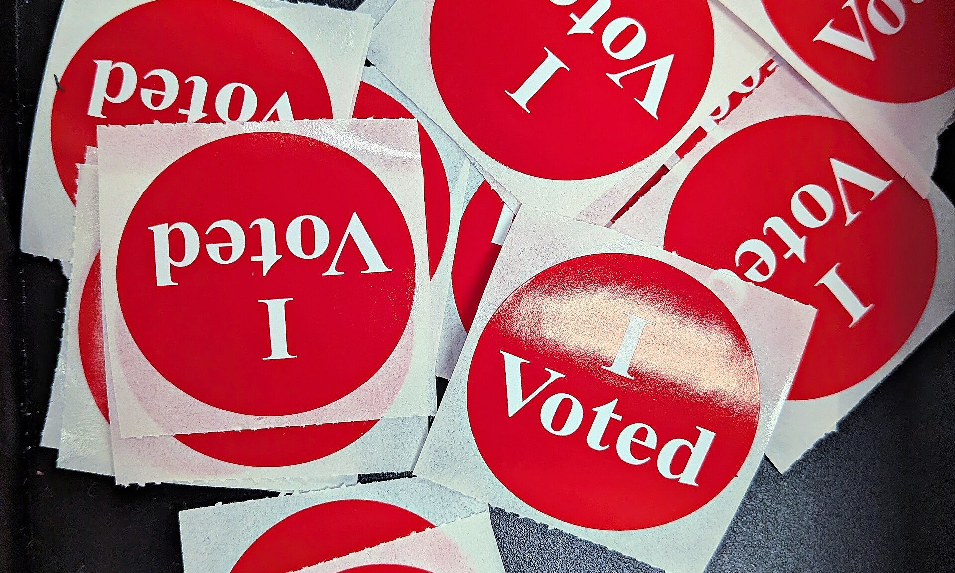 A pile of "I Voted" stickers at a polling station