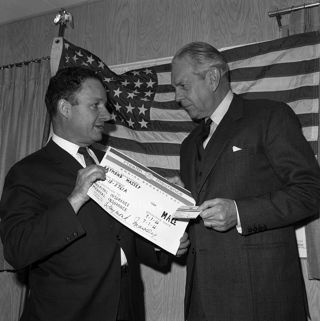 Actor Raymond Massey receiving the first Medicare identification card in 1966